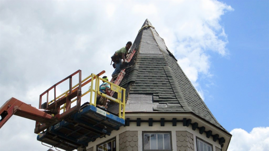 roofer installing asphalt shingle roof